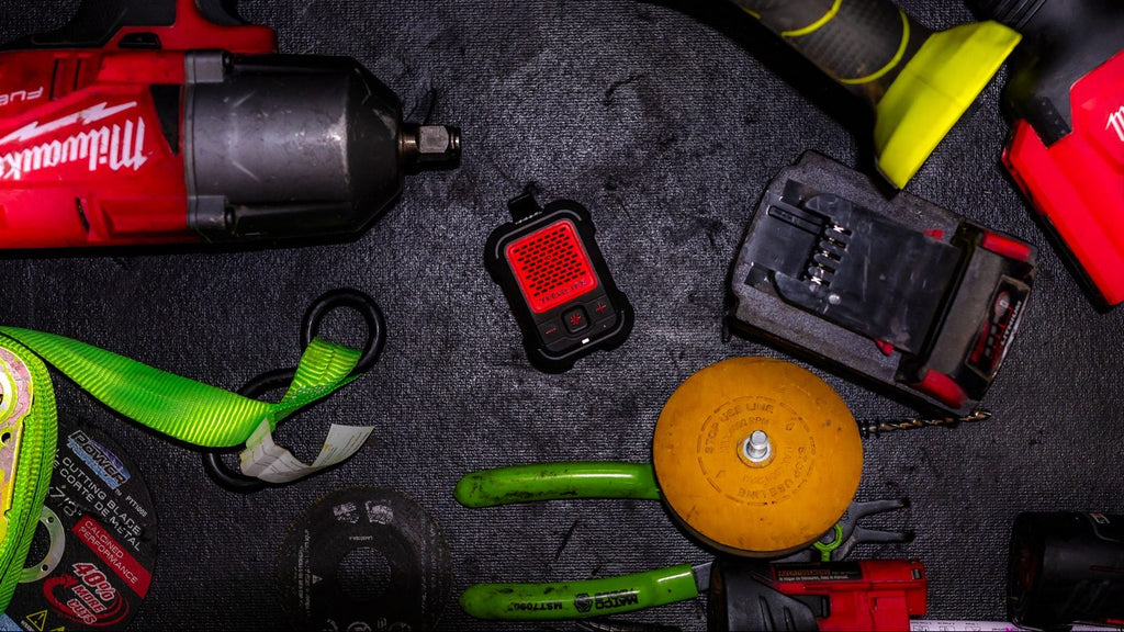 Collection of Milwaukee tools and equipment on a dark surface